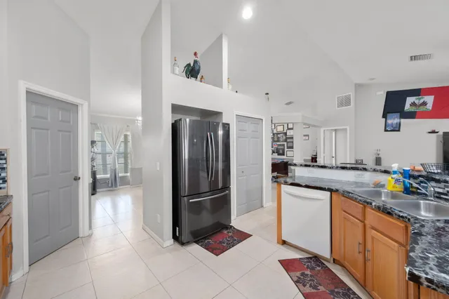 a kitchen with a refrigerator and a sink