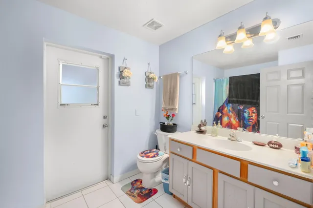 a bathroom with a sink vanity mirror and toilet
