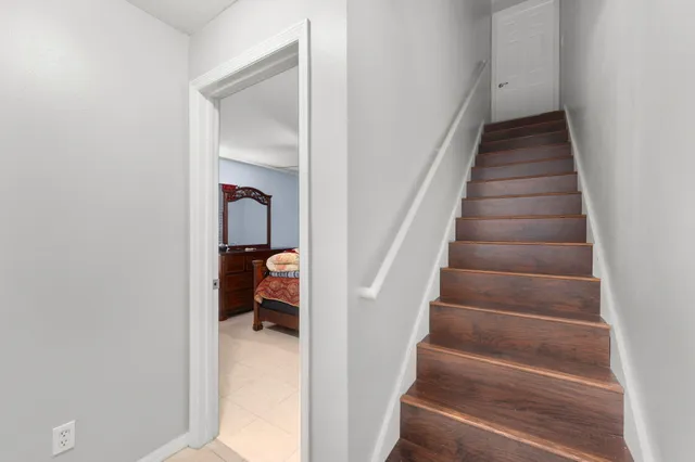 a view of entryway and hall with wooden floor