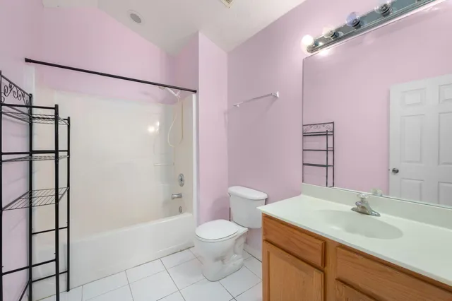 a bathroom with a granite countertop sink toilet a mirror a vanity and shower