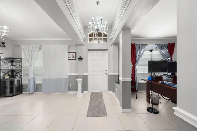 a view of a livingroom with furniture and a chandelier