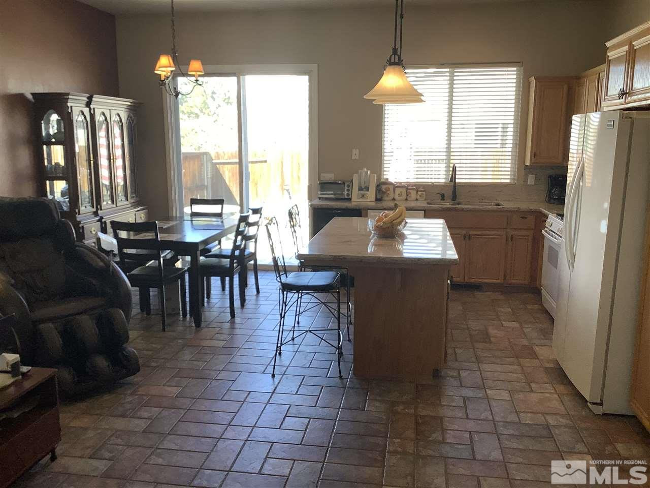 1605 Cattlemen Court Reno, NV 89521 - Photo 4 of 18 a kitchen with a sink a counter top space and stainless steel appliances