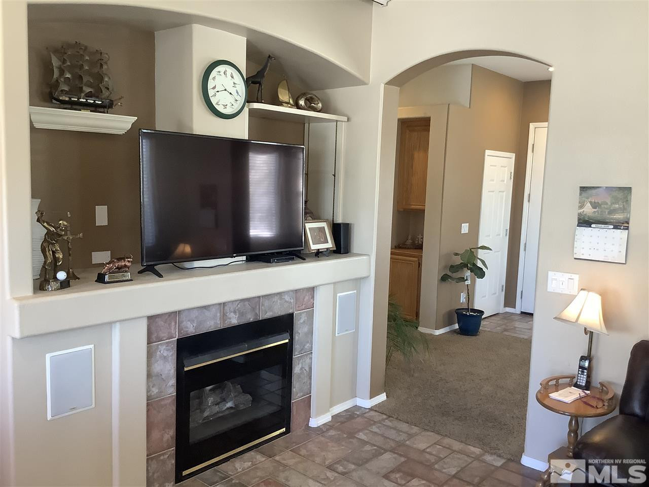 1605 Cattlemen Court Reno, NV 89521 - Photo 6 of 18 a living room with furniture a flat screen tv and a fireplace