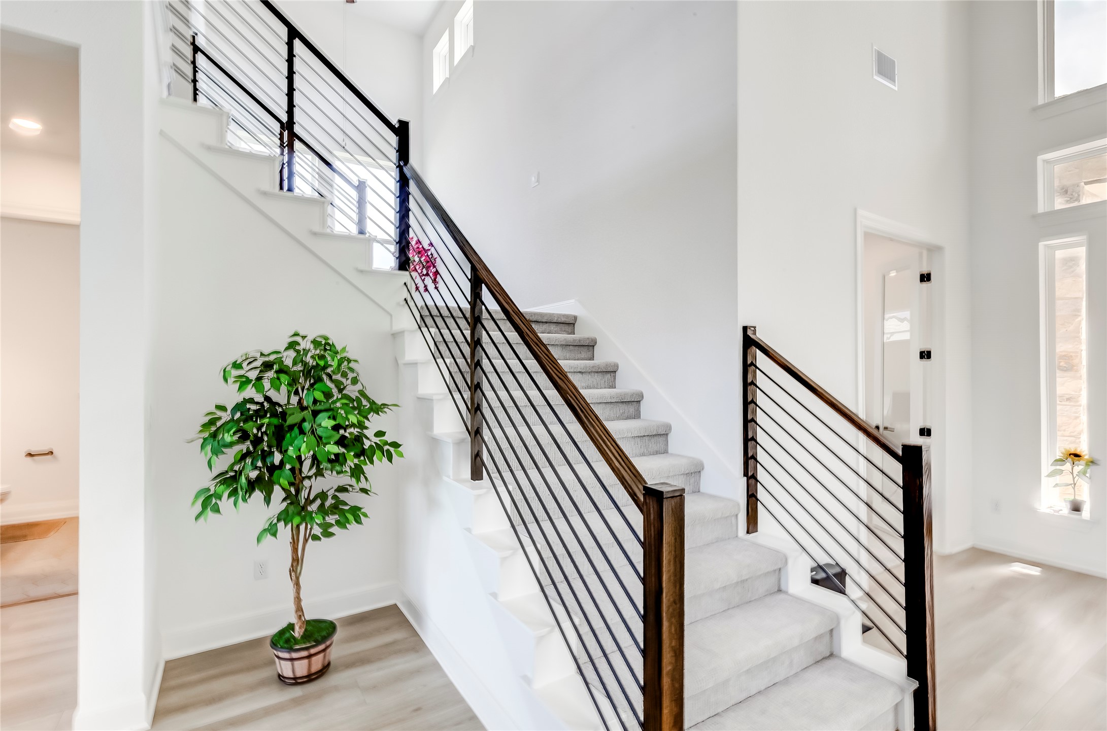 462 Old Stone Road Austin, TX 78737 - Photo 9 of 39 Stairway featuring a high ceiling and wood finished floors
