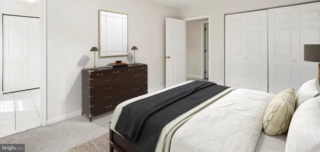 a bedroom with a bed and a mirror