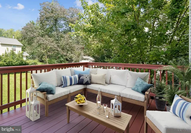 a roof deck with couches and wooden floor