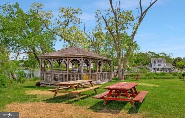 a backyard of a house with barbeque oven fire pit table and chairs