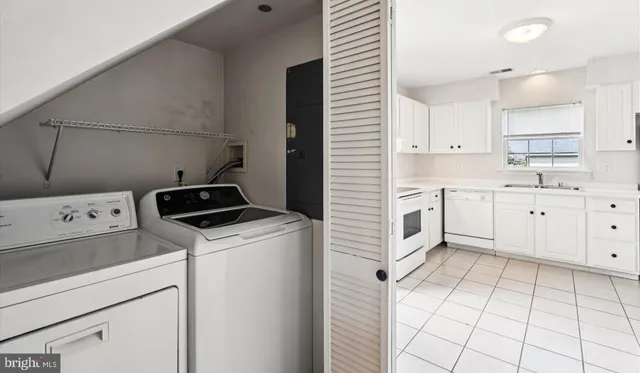 a room with a stove a sink and a refrigerator