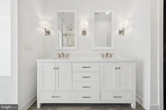 a bathroom with white cabinets and a sink