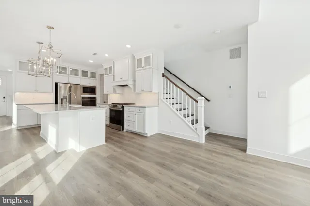 a view of a living room kitchen with furniture and fireplace