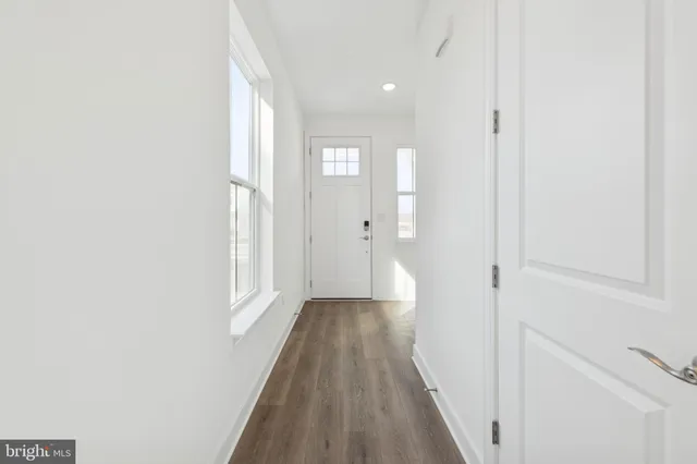 a view of a hallway with wooden floor