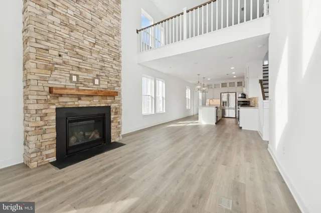 a view of a livingroom with wooden floor and a fireplace