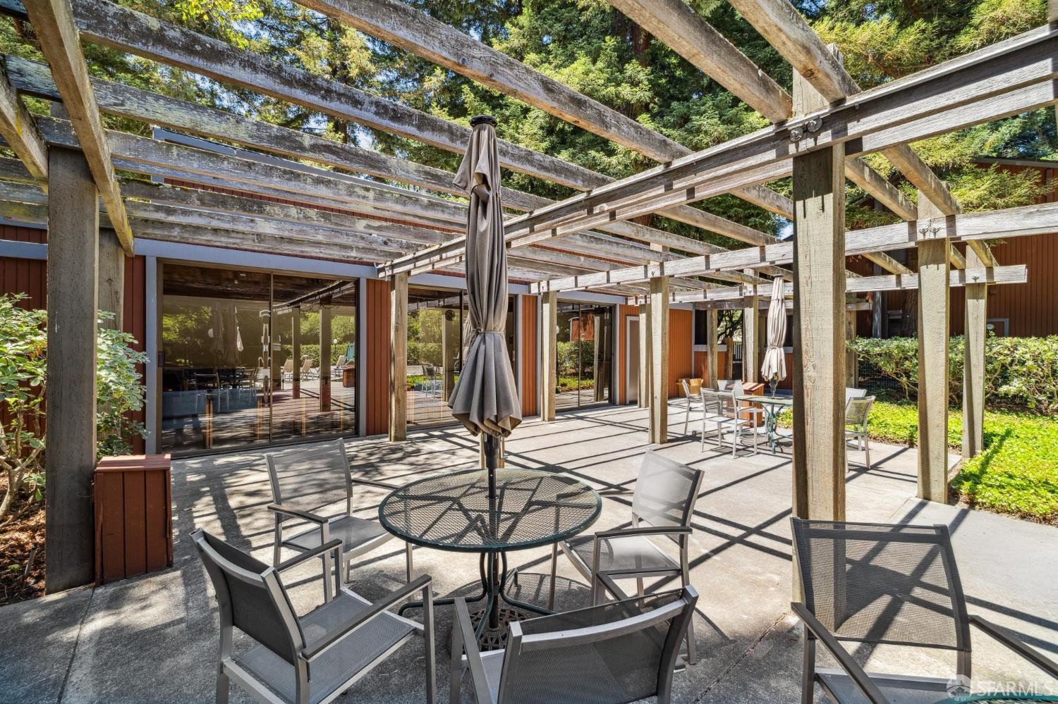 229 Cypress Point Drive Mountain View, CA 94043 - Photo 29 of 32 a view of a patio with table and chairs and potted plants