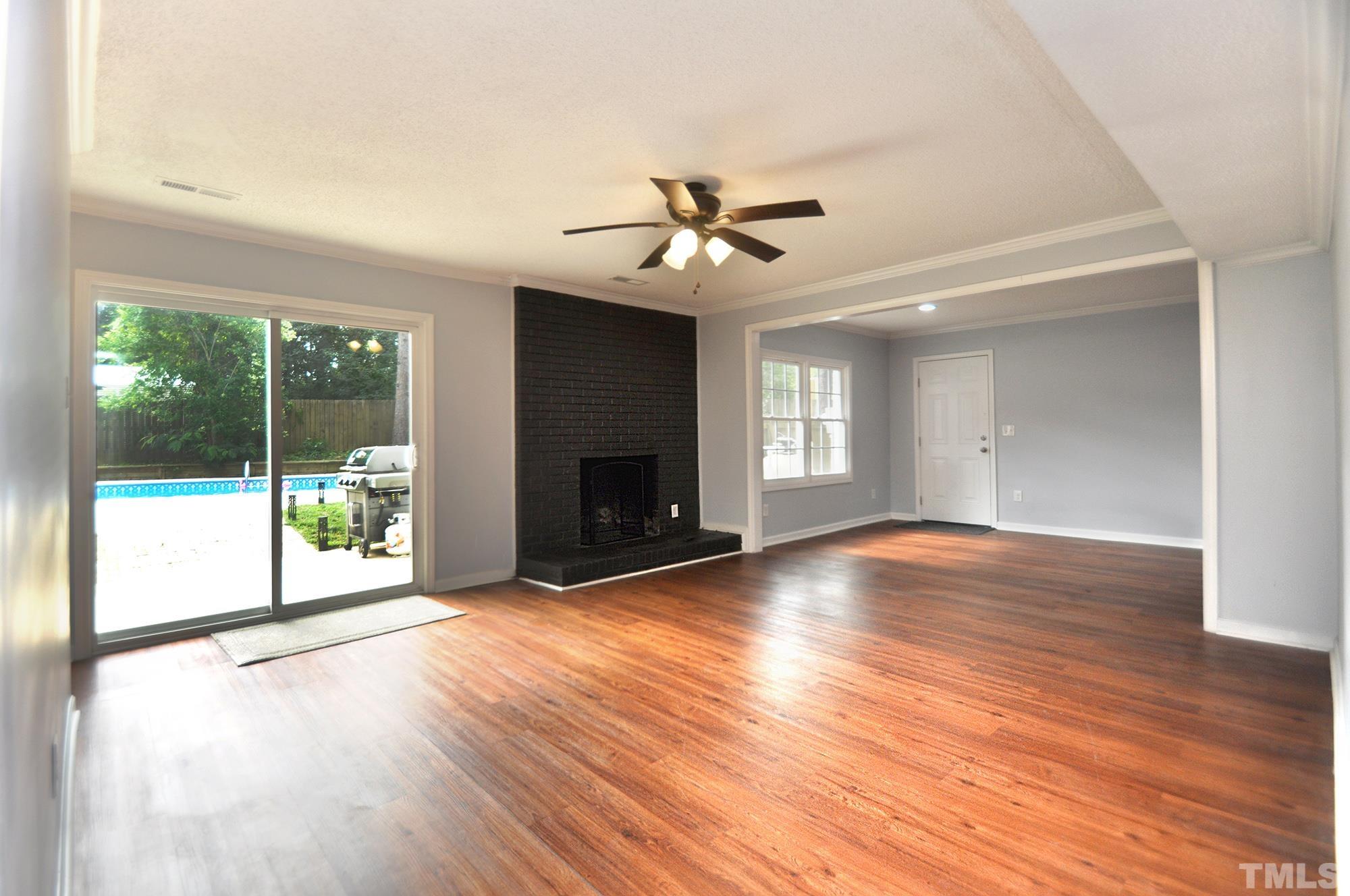 2401 Sanderford Road Raleigh, NC 27610 - Photo 11 of 31 a view of an empty room with wooden floor and a window