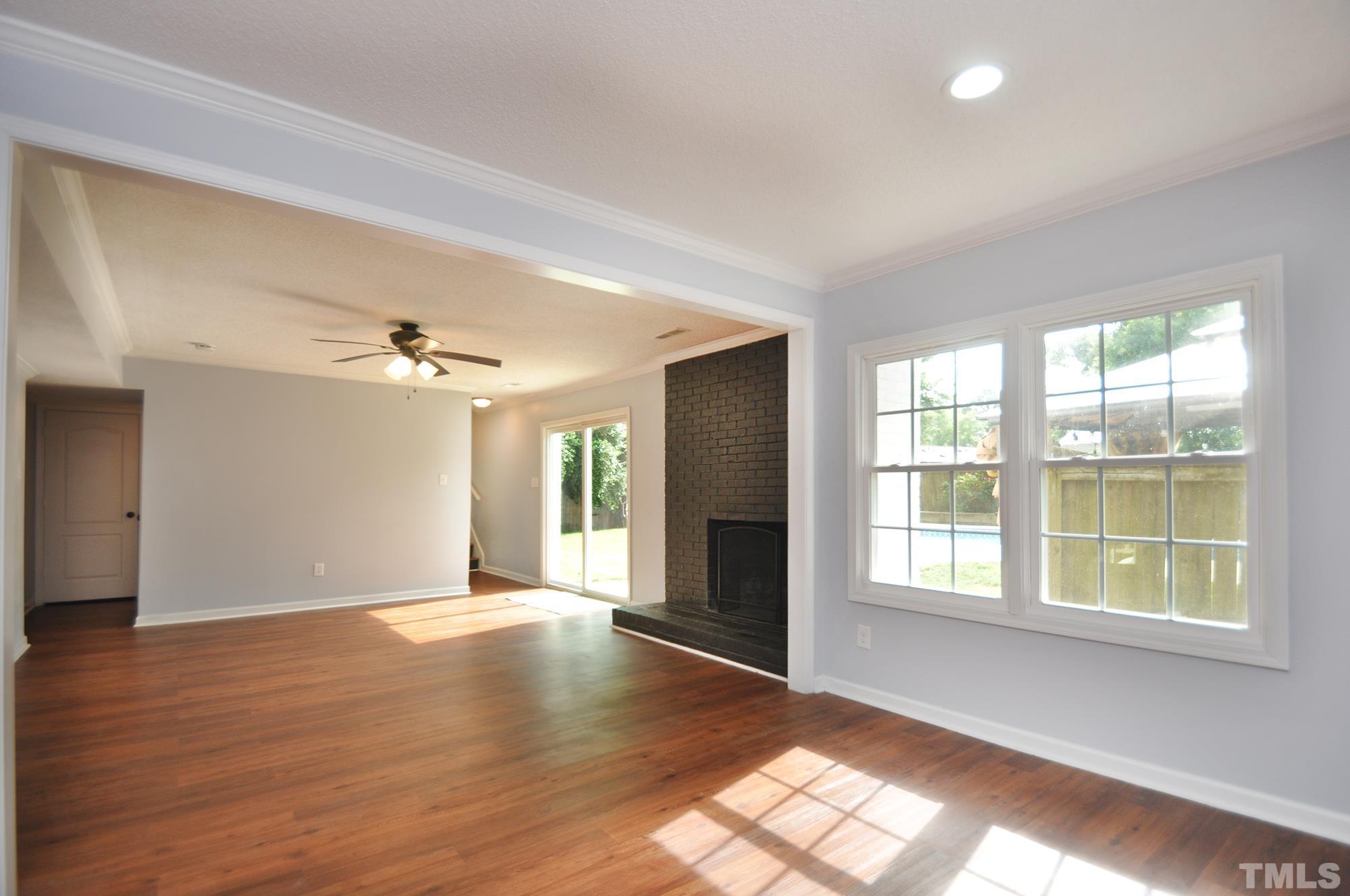 2401 Sanderford Road Raleigh, NC 27610 - Photo 13 of 31 a view of an empty room with a window and wooden floor