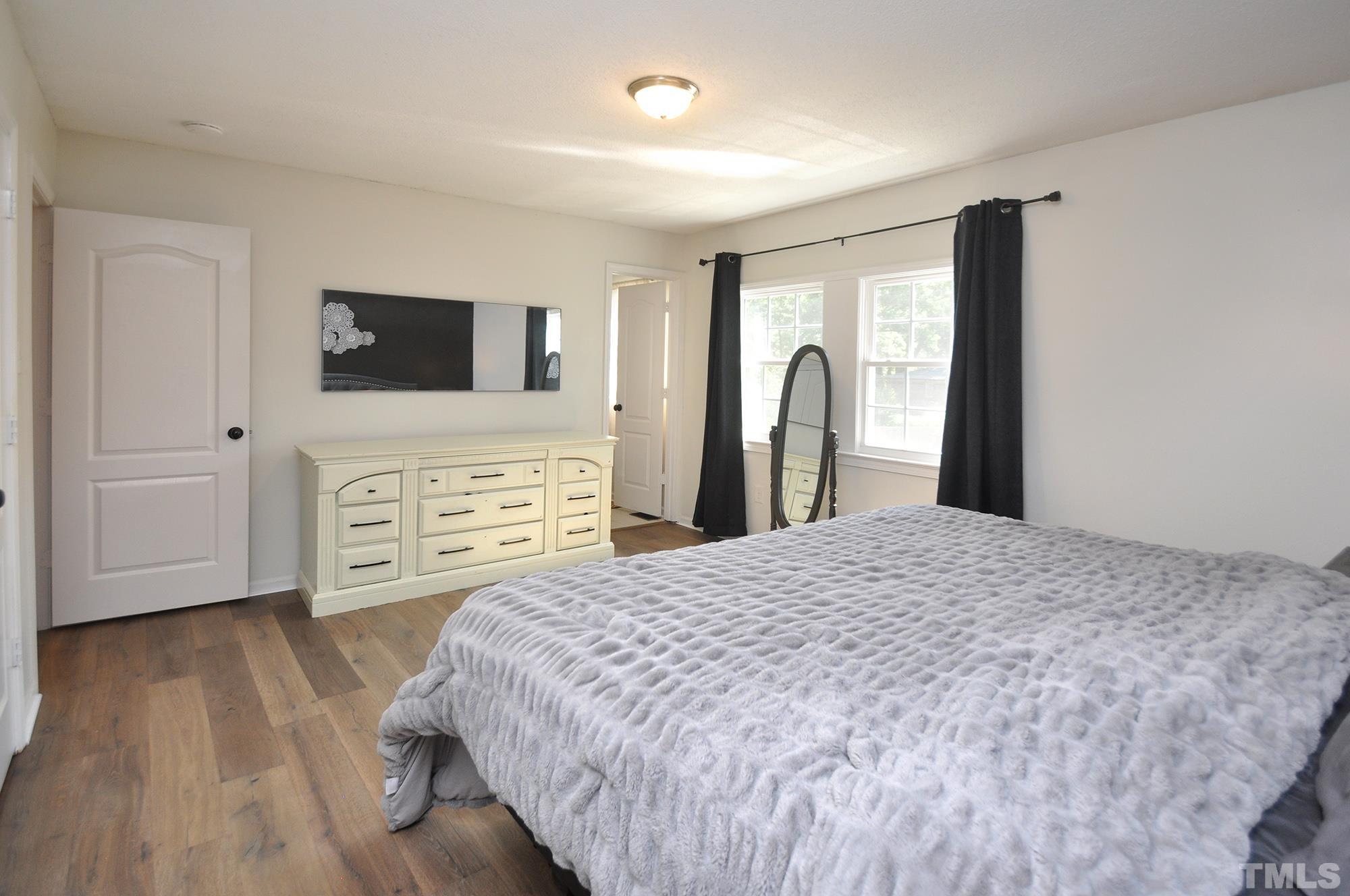 2401 Sanderford Road Raleigh, NC 27610 - Photo 18 of 31 a bedroom with a bed and a television
