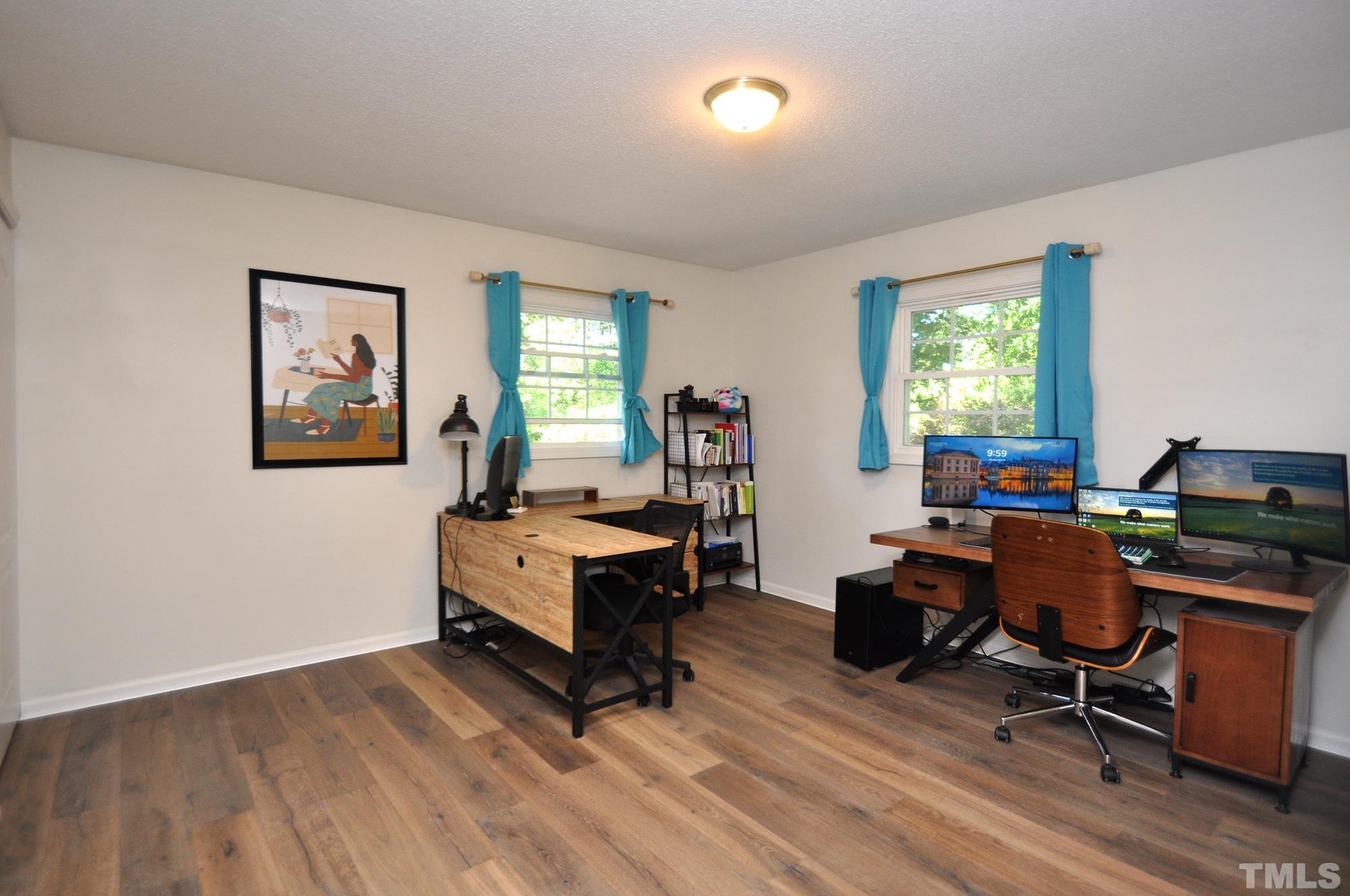 2401 Sanderford Road Raleigh, NC 27610 - Photo 21 of 31 a view of a livingroom with workspace and a window