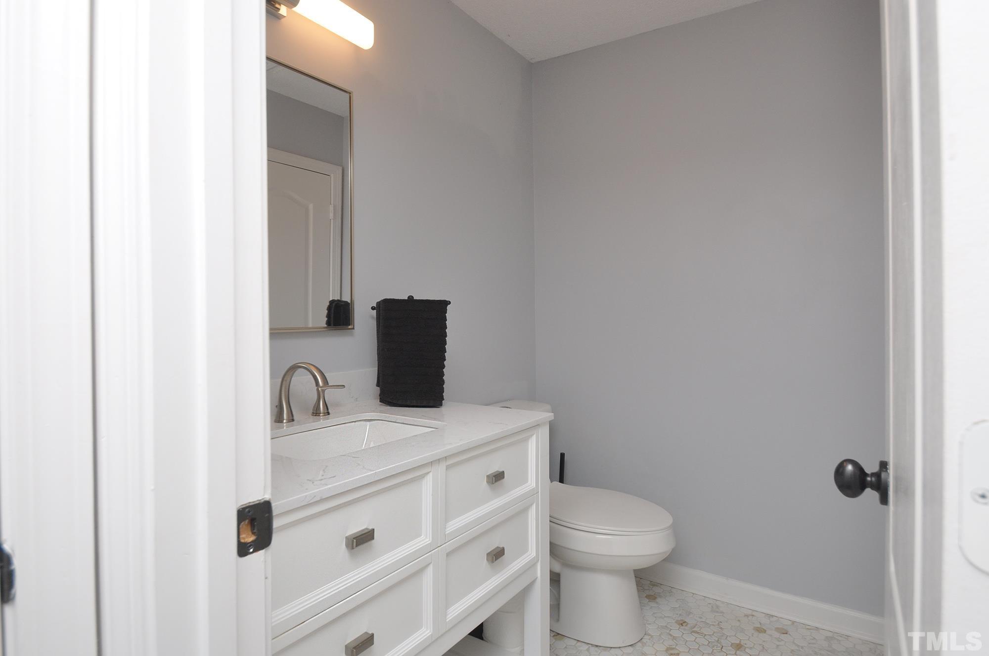2401 Sanderford Road Raleigh, NC 27610 - Photo 23 of 31 a bathroom with a toilet sink and mirror