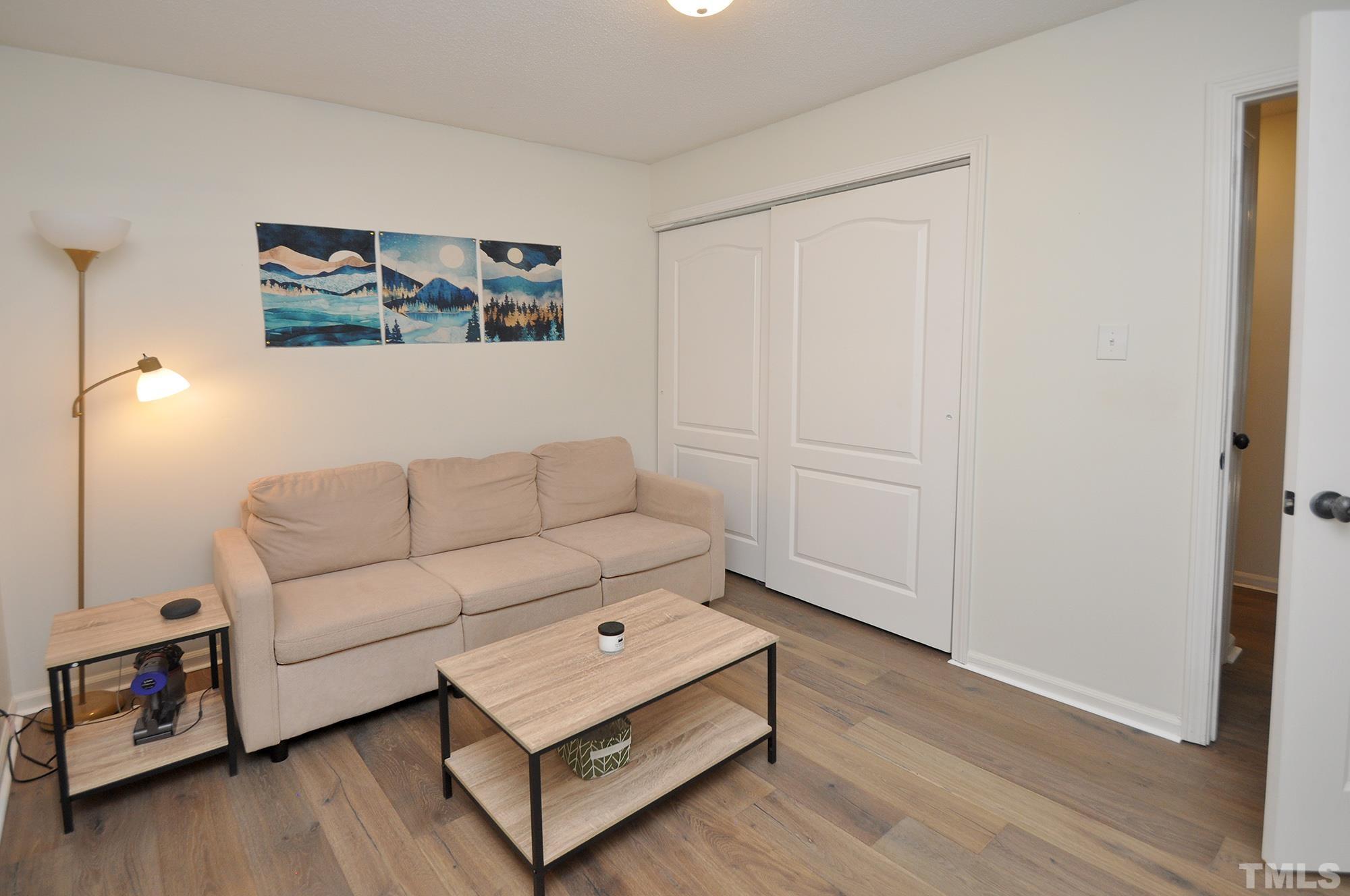 2401 Sanderford Road Raleigh, NC 27610 - Photo 25 of 31 a living room with furniture and a wooden floor