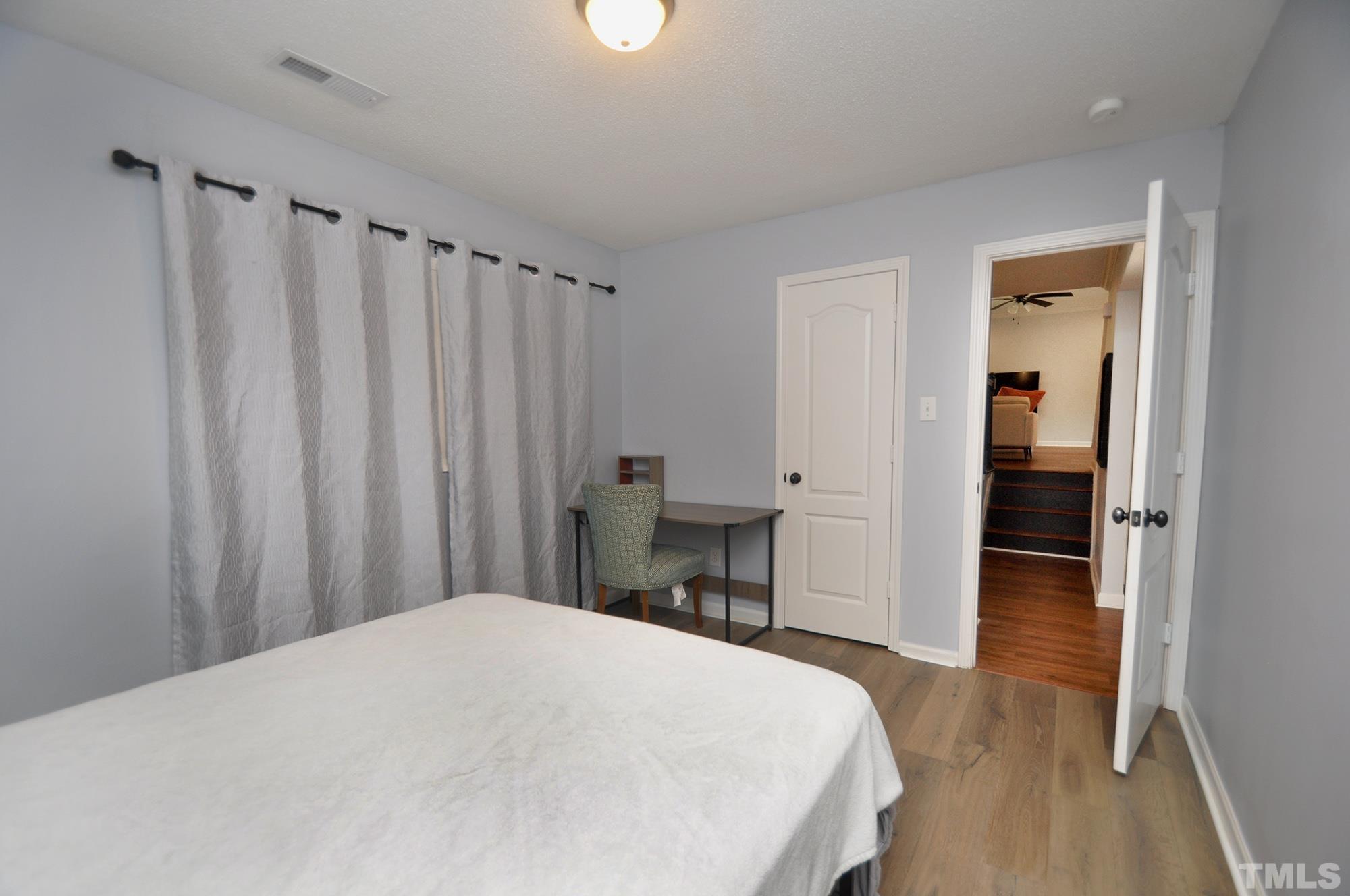 2401 Sanderford Road Raleigh, NC 27610 - Photo 28 of 31 a bedroom with a bed and a table