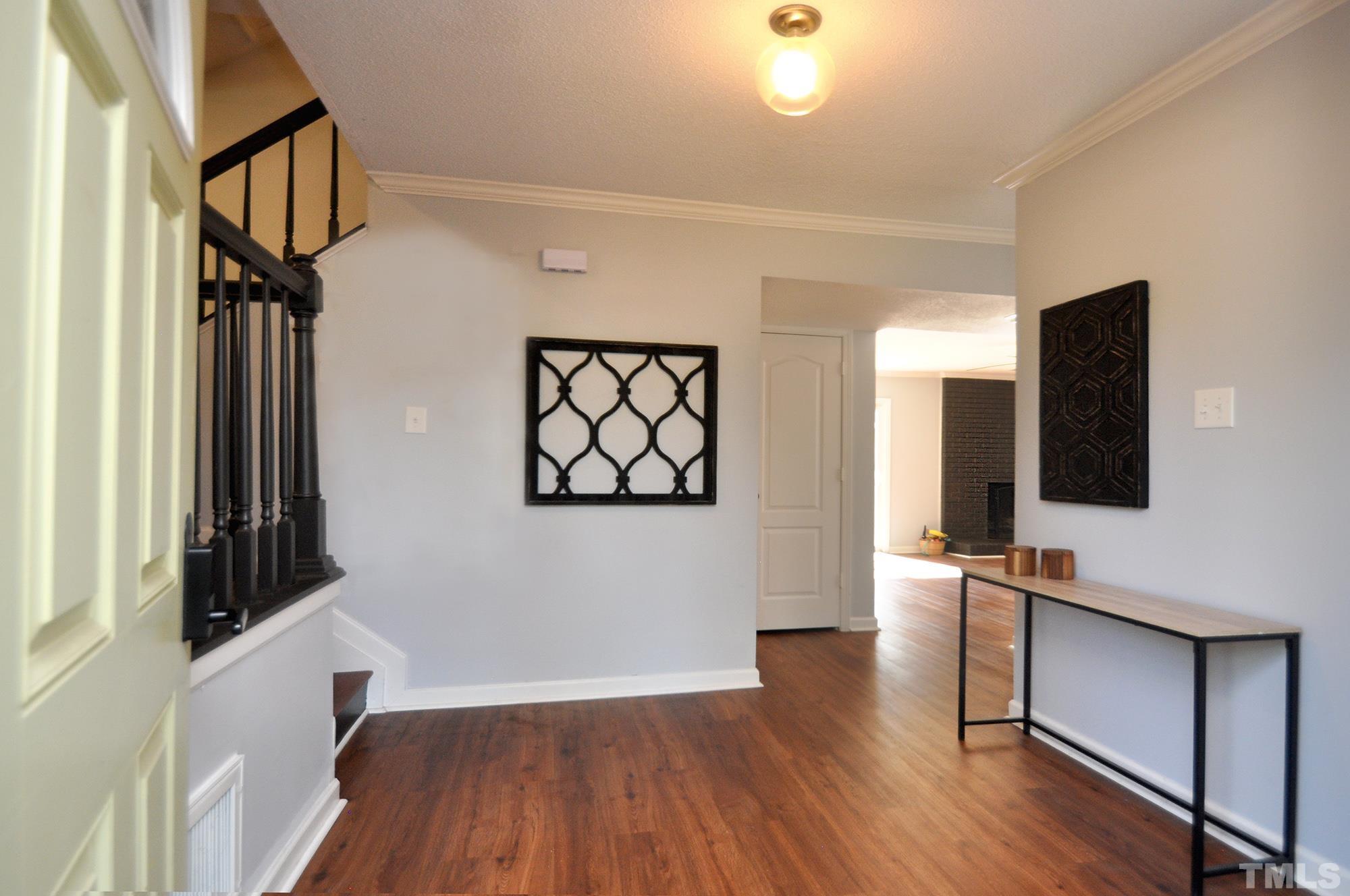 2401 Sanderford Road Raleigh, NC 27610 - Photo 3 of 31 wooden floor in an empty room with a window