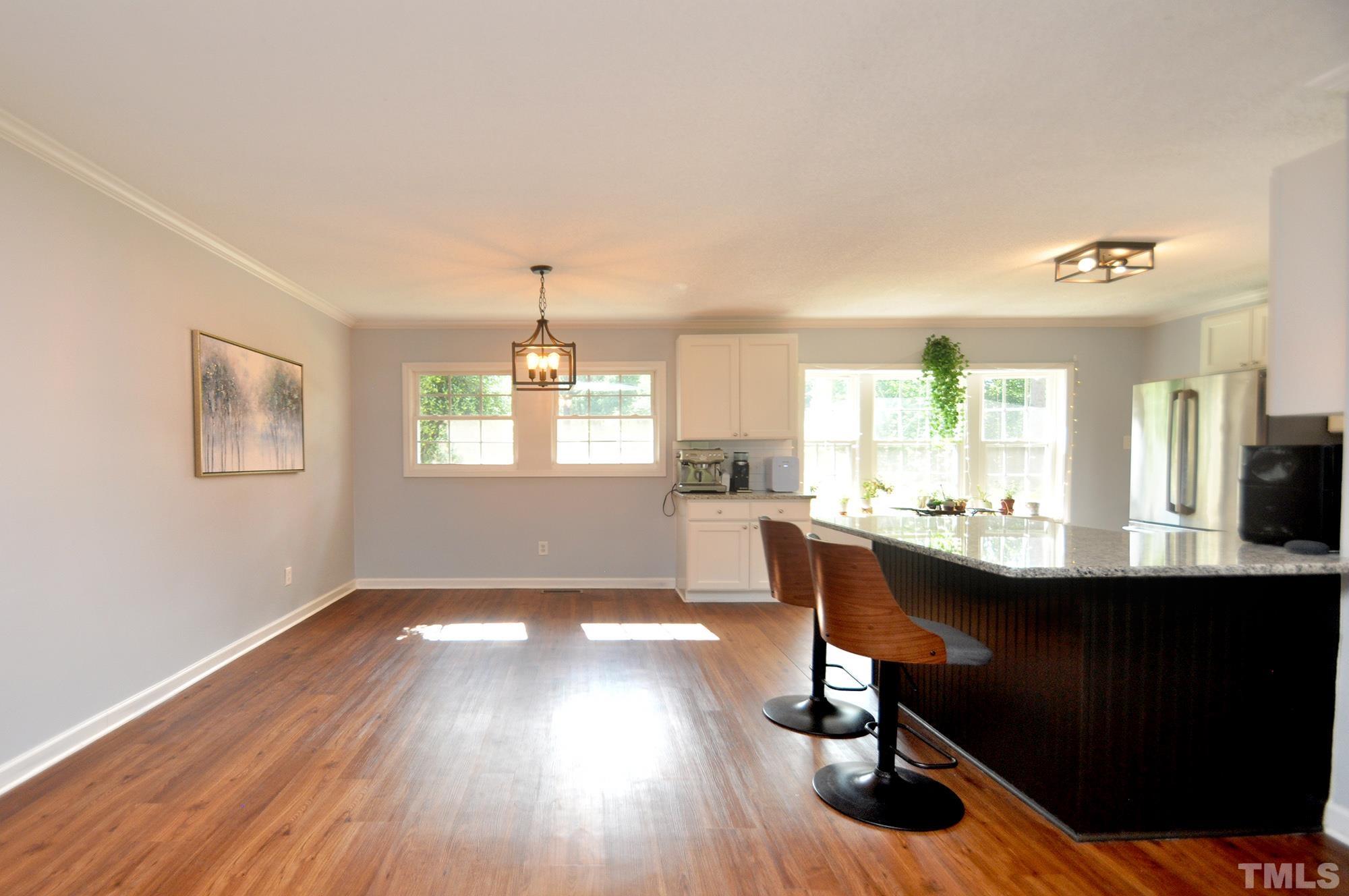 2401 Sanderford Road Raleigh, NC 27610 - Photo 10 of 31 a view of a dining room with furniture and wooden floor
