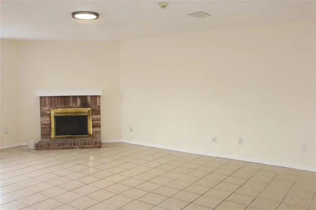 an empty room with a fireplace