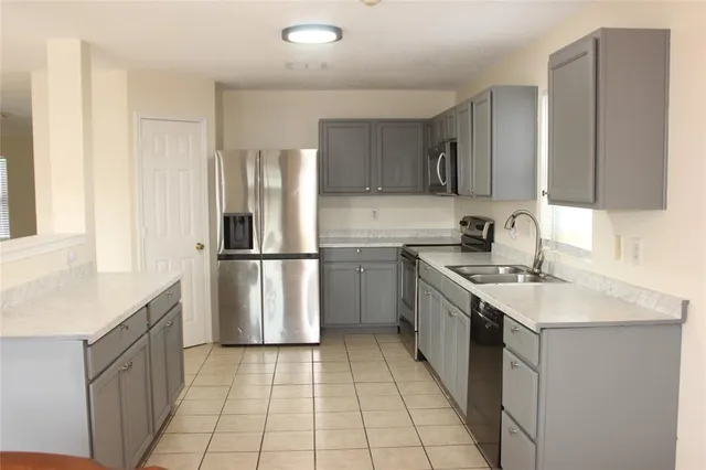 a kitchen with a sink stove and refrigerator