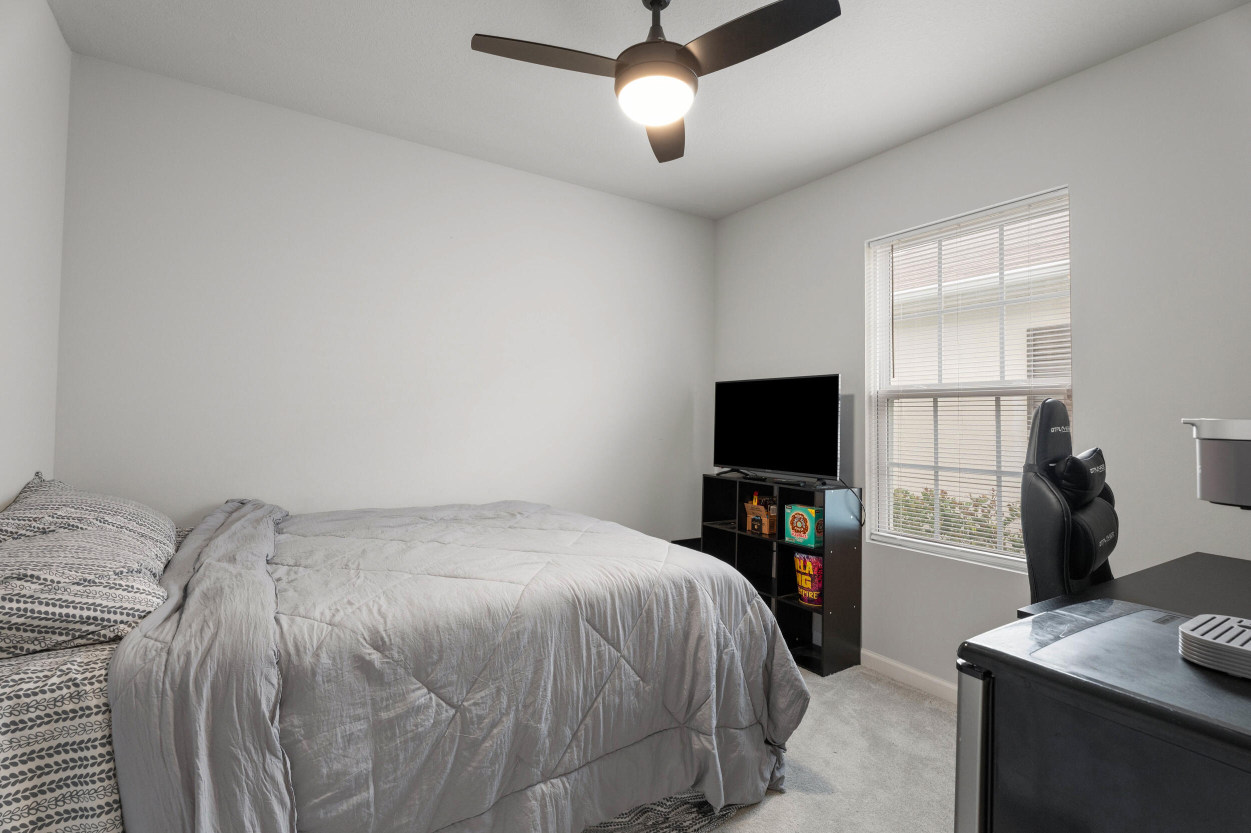 271 Raspberry Road Fort Pierce, FL 34981 - Photo 15 of 42 a bedroom with a bed and a flat tv screen on a dresser