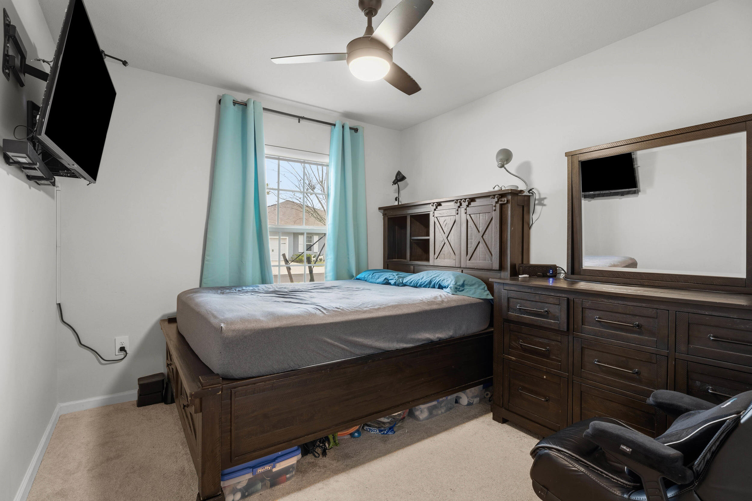 271 Raspberry Road Fort Pierce, FL 34981 - Photo 18 of 42 a bedroom with a bed and a flat screen tv