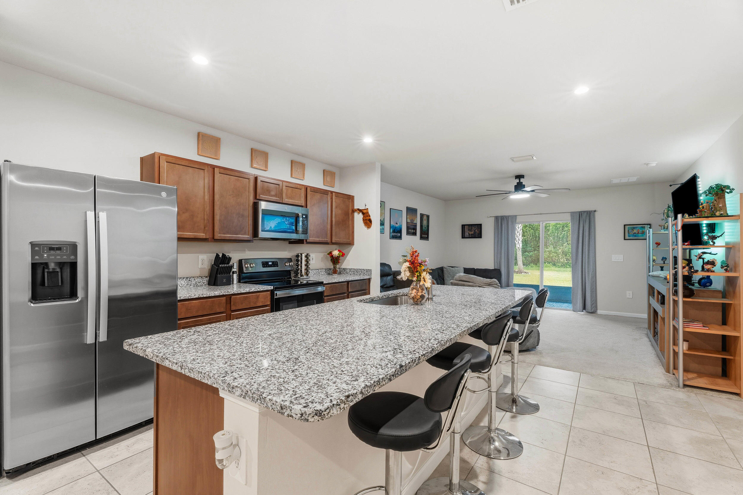 271 Raspberry Road Fort Pierce, FL 34981 - Photo 4 of 42 a kitchen with stainless steel appliances granite countertop a sink counter space and chairs in it
