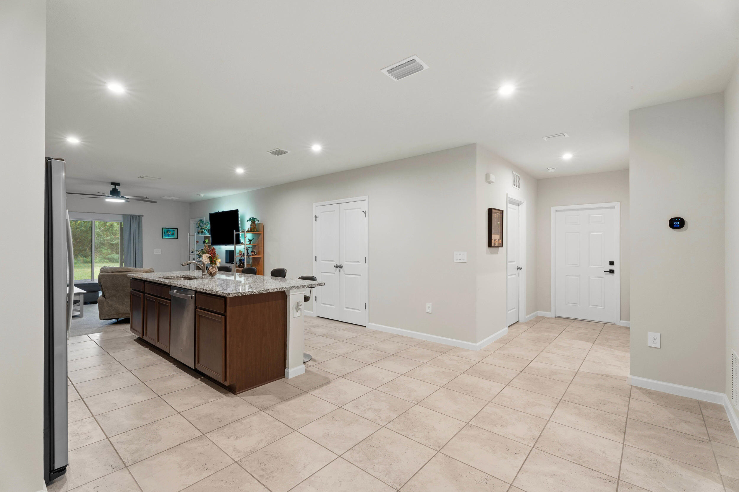 271 Raspberry Road Fort Pierce, FL 34981 - Photo 7 of 42 a large white kitchen with kitchen island granite countertop a large counter top and a sink with garden