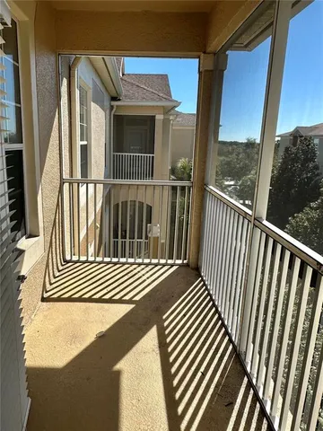 a view of a brick house with a tree in the background