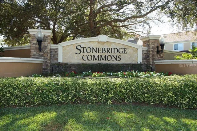 a sign that is sitting in front of flowers