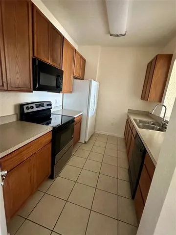a kitchen with stainless steel appliances a stove a microwave and a refrigerator