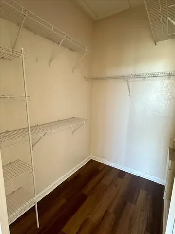 a view of a room with wooden floor