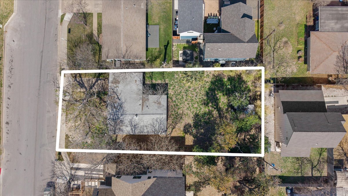 Aerial perspective of suburban area featuring property boundaries highlighted