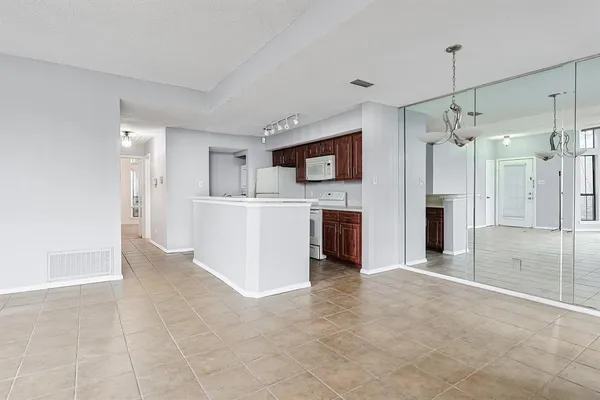 a view of a kitchen with a sink and a refrigerator