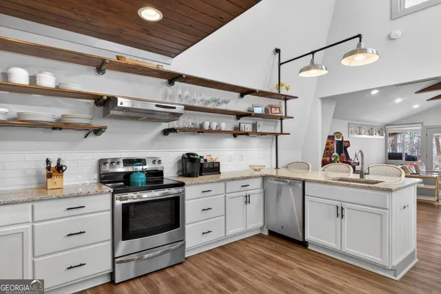 a kitchen with cabinets and wooden floor