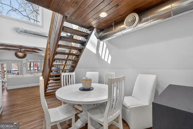 a view of a dining room with furniture and wooden floor