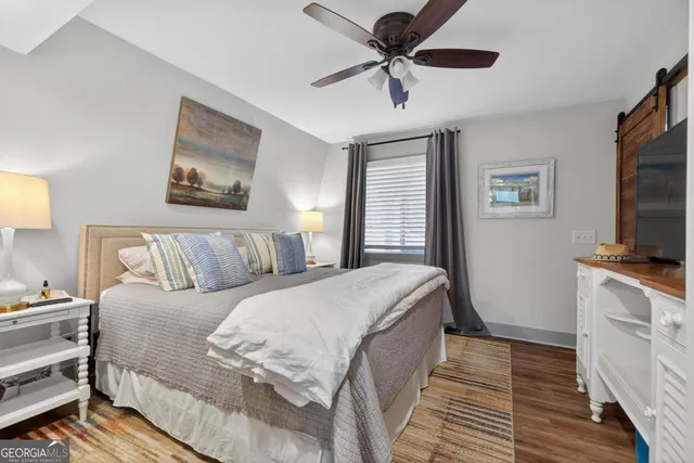 a living room with a bed and a flat screen tv