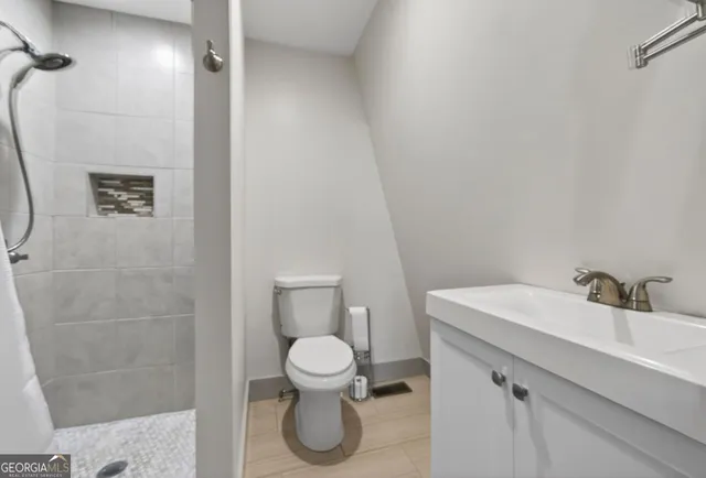 a bathroom with a toilet sink and shower