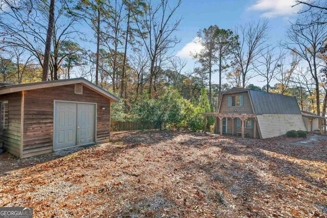 a view of a house with large trees