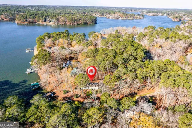 an aerial view of a houses with a lake view