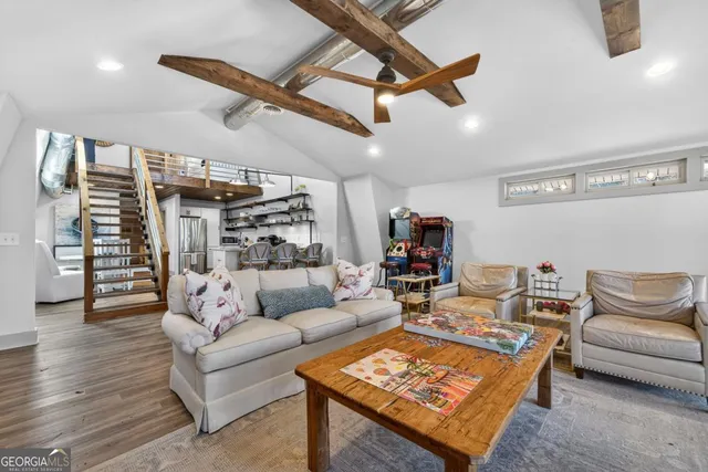 a living room with furniture and a wooden floor