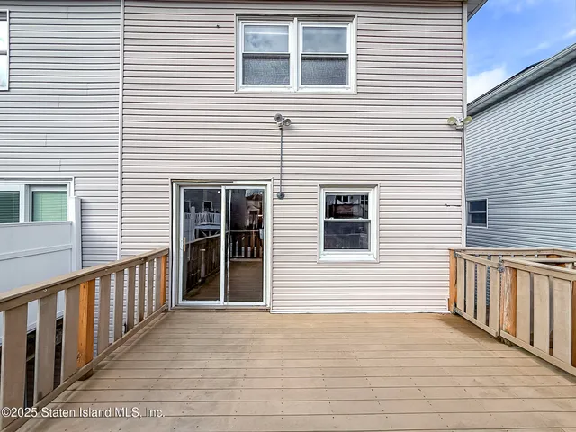 a view of a house with wooden deck