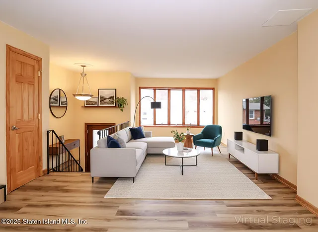 a living room with furniture and a large window