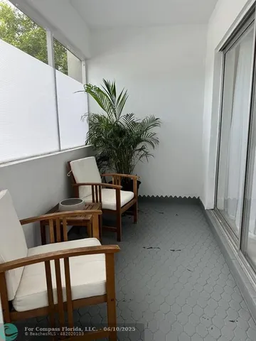 a view of a porch with furniture and a potted plant