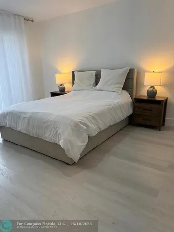 a bedroom with a bed and a lamp