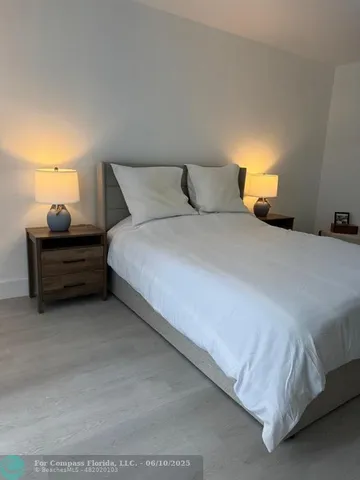 a bedroom with bed and window